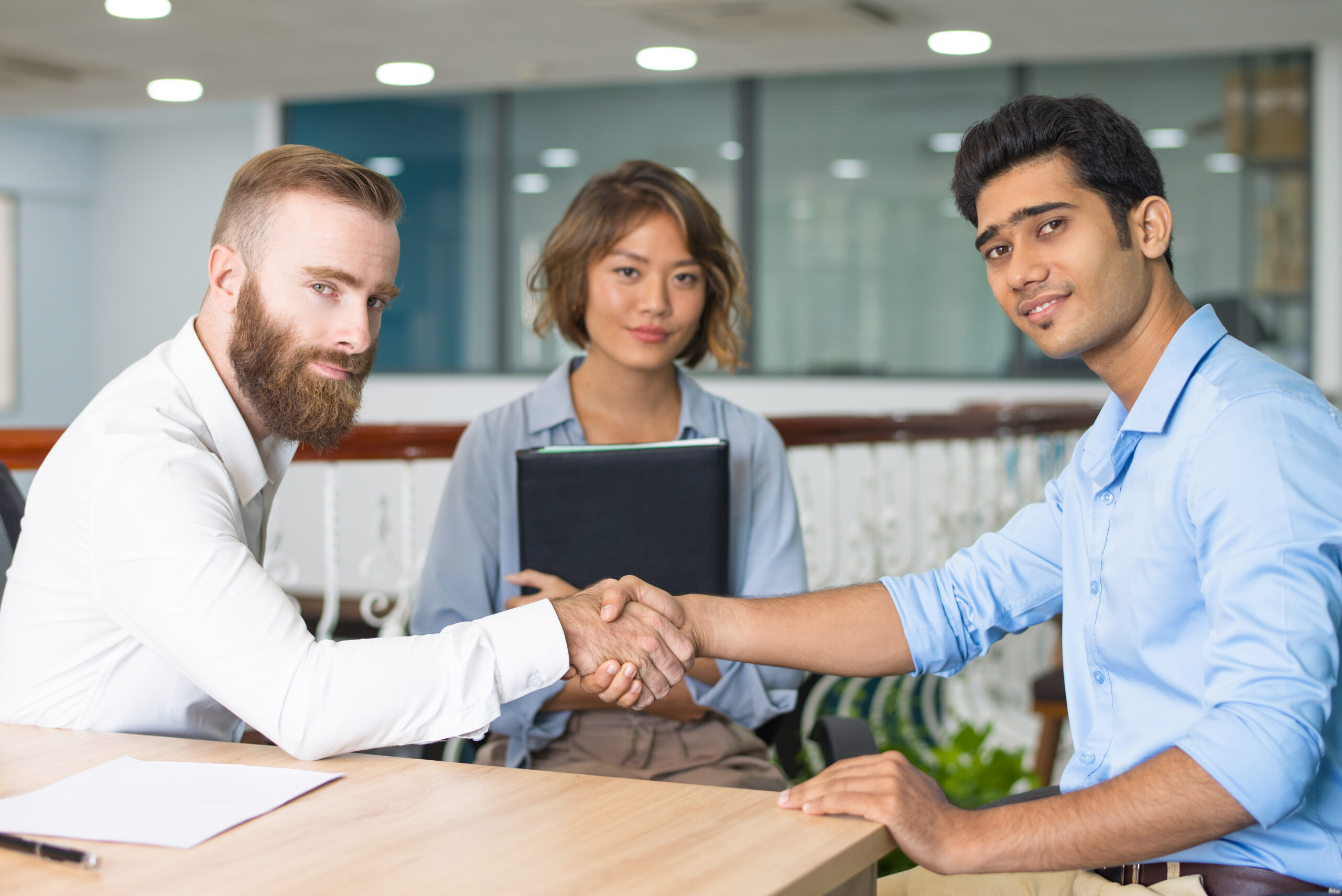 Content Indian candidate shaking hands with company leader